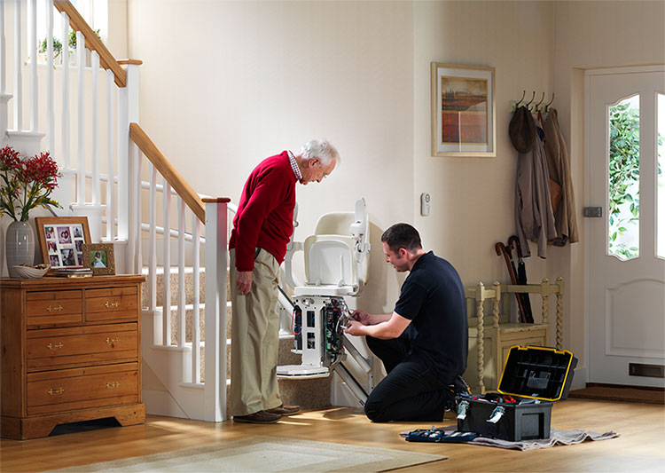 professional technician changing stairlift batteries